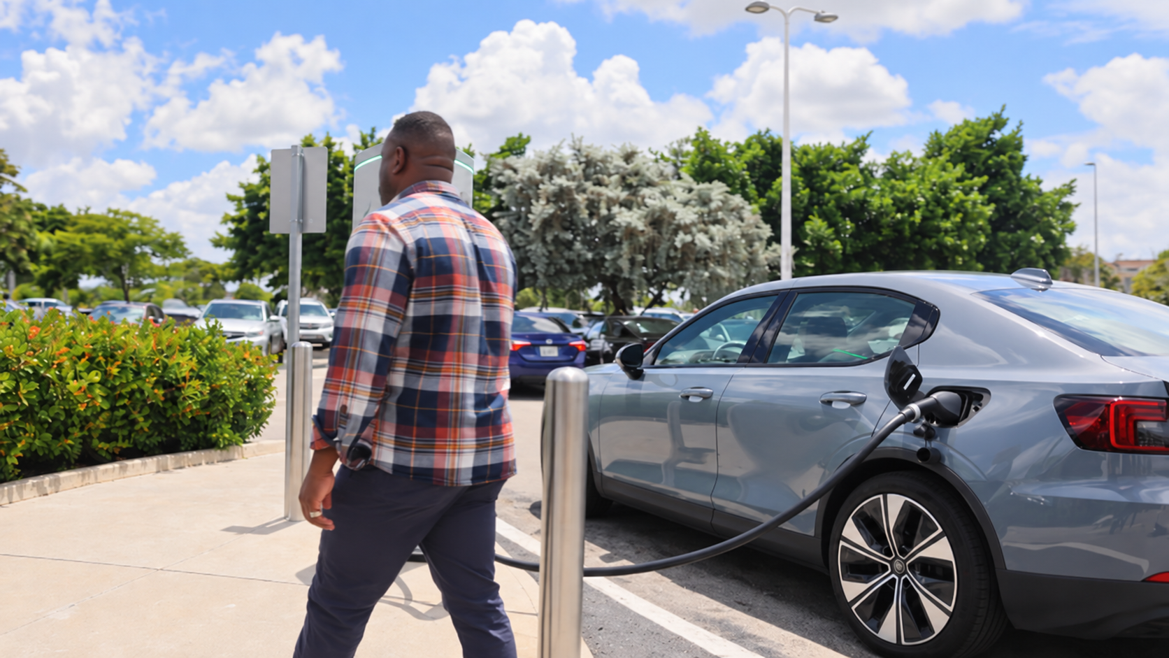 Electric vehicle charging at a WGE station as the driver walks away